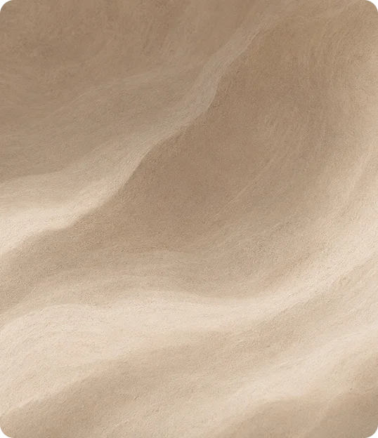 Soft beige fabric with gentle folds and subtle sheen creating elegant draping texture