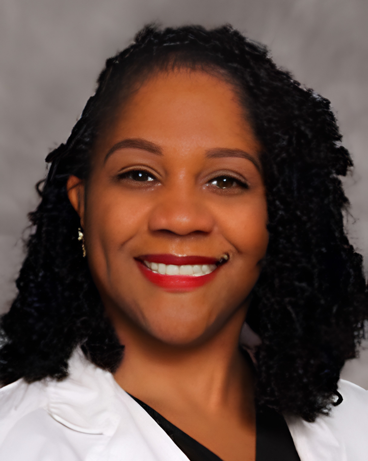 Deanne Walker-DuPree, family nurse practitioner, smiling in white medical coat