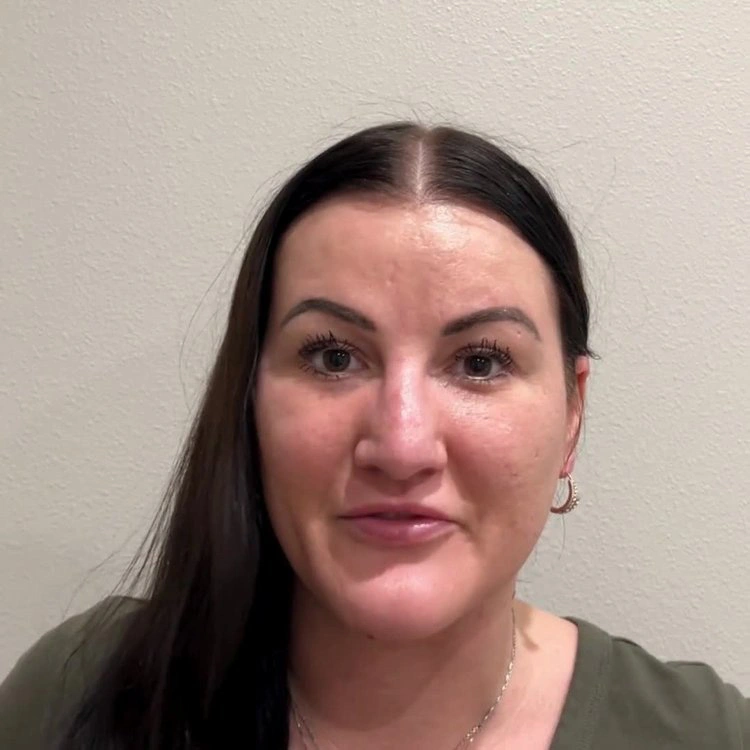 Woman with dark hair and olive shirt sharing her healthcare experience in patient testimonial